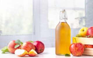 Apple cider vinegar on a table in a fermentation bottle.